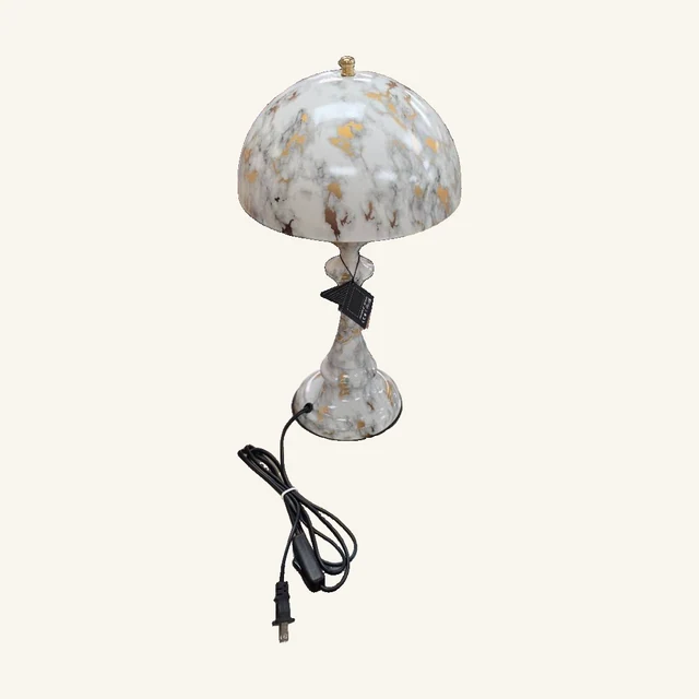 Marble-Pattern Table Lamp — Silver/Gold Assortment. A rounded shade and sculptural base bring a soft marble-patterned accent to a table or shelf.