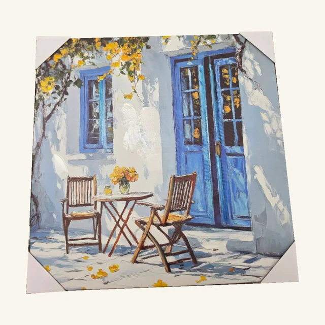 Afternoon in Majorca II. Blue doors, a small café table and dappled light bring the feel of a quiet Mediterranean afternoon.
