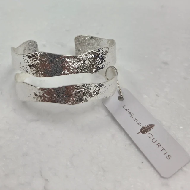 Angelica Hammered Cuff Bracelet — Silver Tone. Open bands and a hammered silver-toned finish give this cuff an airy, sculptural shape.
