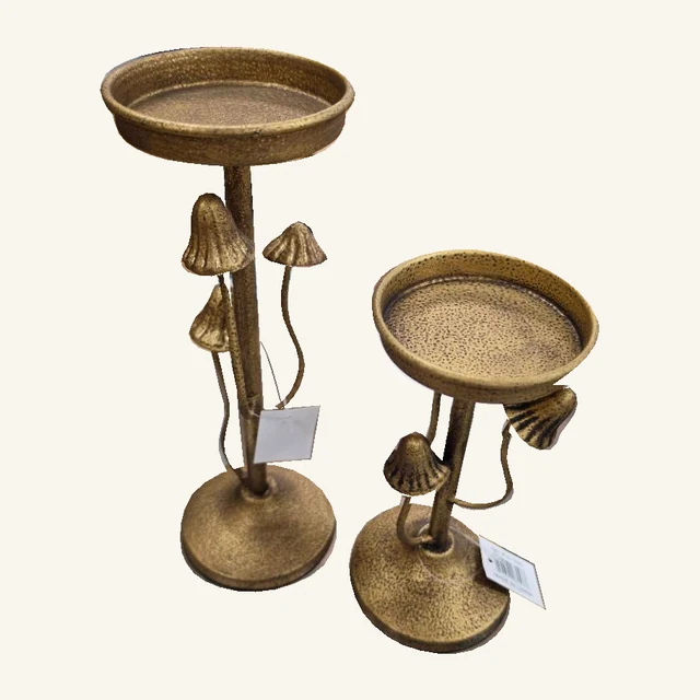 Two antique-gold pedestal candle holders with mushroom ornaments, round trays, bases and original hanging tags