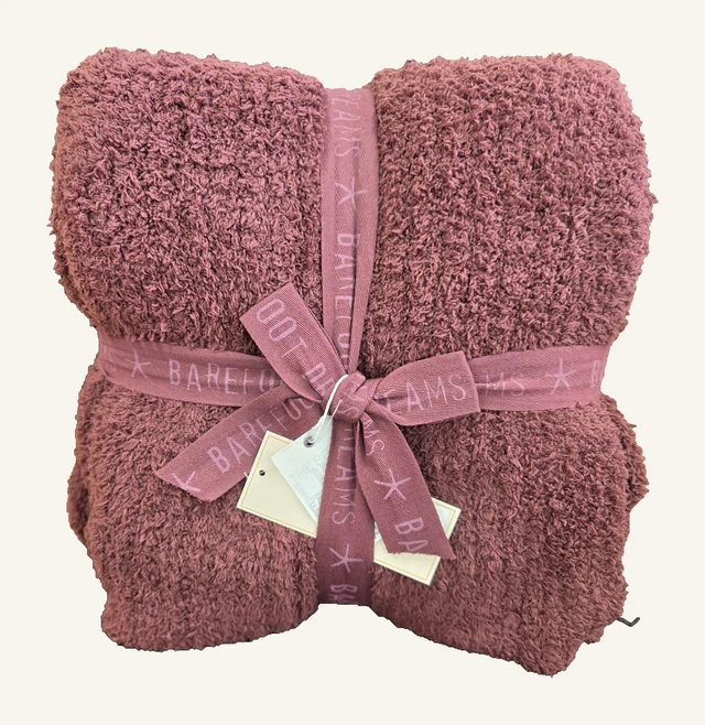 Deep Garnet CozyChic Ribbed throw by Barefoot Dreams, folded with its original matching ribbon and attached tags.