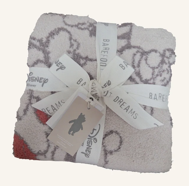 Winnie the Pooh and Friends Stroller Blanket — Almond Multi by Barefoot Dreams, shown folded with original ribbon and tags