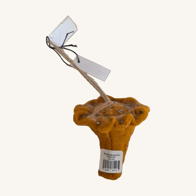 One orange beaded wool-felt mushroom ornament with its complete cap, stem, hanging loop, attached tags and original retail sticker.