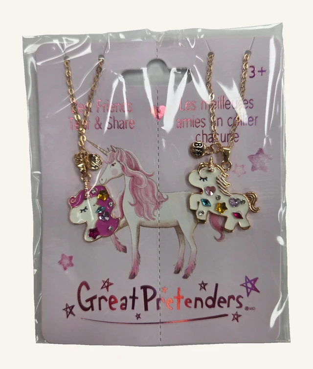 Two different bejewelled unicorn pendants on gold-toned chains, together on their original Best Friends Tear & Share card in its clear retail sleeve.