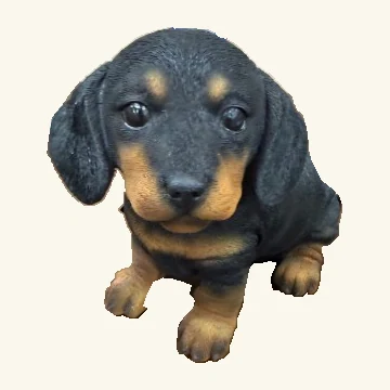 Black dachshund puppy figurine.