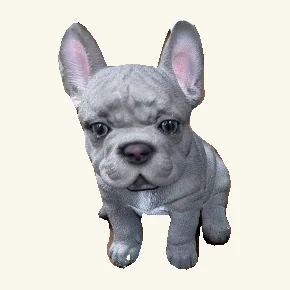 Blue-gray French bulldog puppy figurine sitting with its complete upright ears and visible paws.