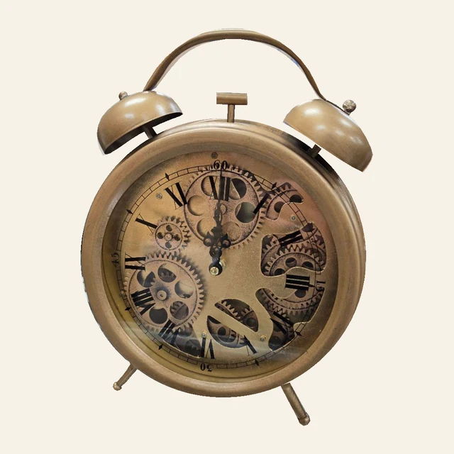 Brass-tone twin-bell-style table clock with Roman numerals, dark hands, visible gear design, arched handle, and two feet.