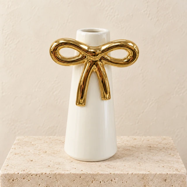 Tall ivory Coquette Budvase with an oversized metallic-gold bow