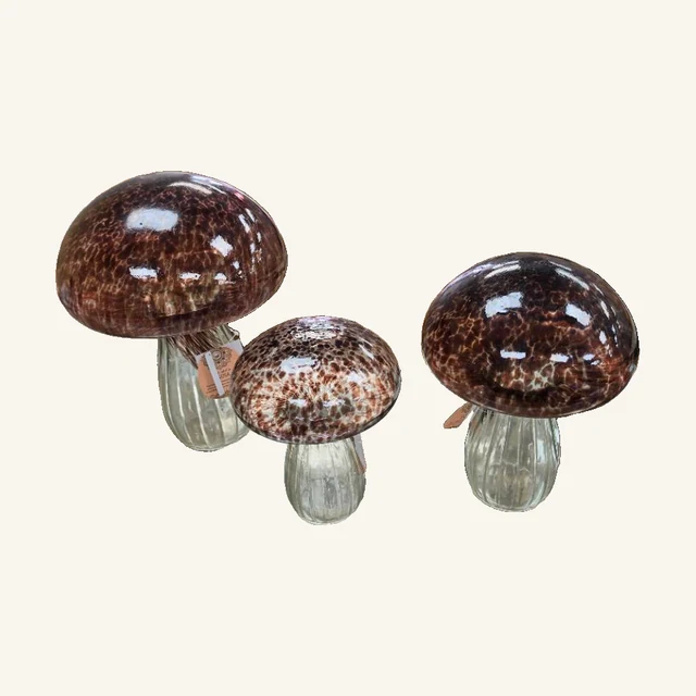 Decorative Glass Mushrooms — Set of Three. Mottled brown caps and clear ribbed stems give this three-piece mushroom set its woodland charm.