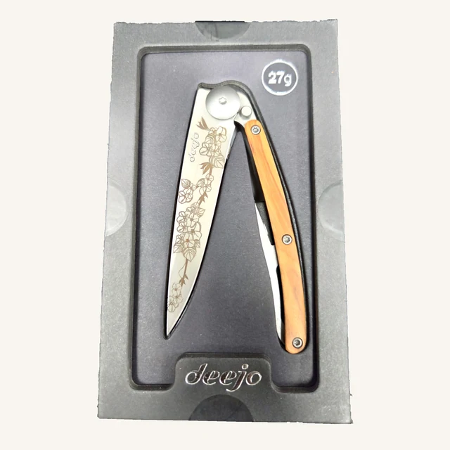 Deejo Cherry Blossom 27g knife with floral engraving and olive-wood handle in its black presentation tray