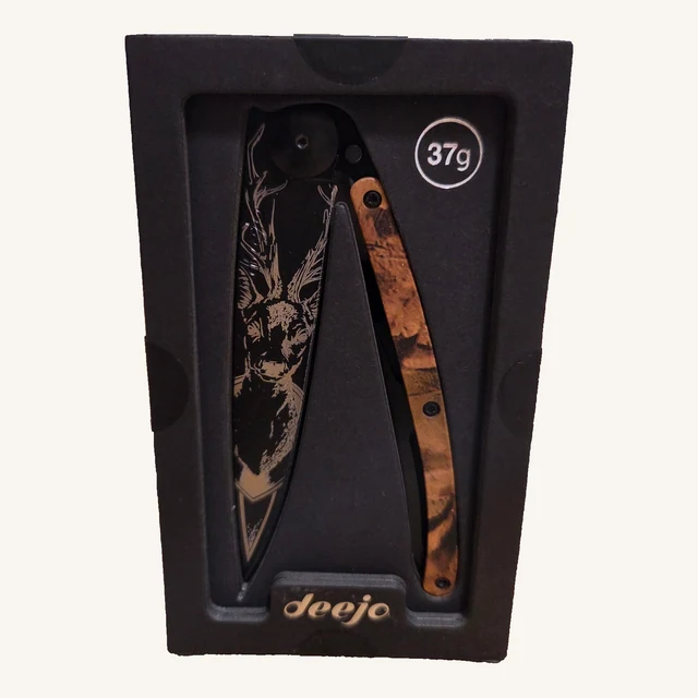 Deejo Deer 37g folding knife with a deer-head blade design and brown-camouflage handle in its black presentation tray