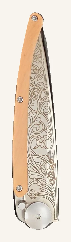 Actual folded Deejo floral-engraved knife with a warm-toned handle and round metal pivot