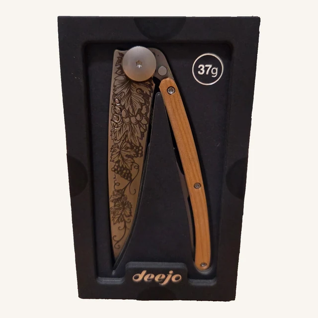 Deejo Grand Cru 37g knife with grapevine engraving and juniper-wood handle in its black presentation tray