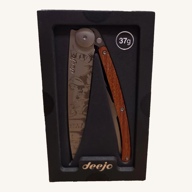 Deejo Hunting Day 37g folding knife with an engraved deer-and-forest blade and coral-wood handle in its black presentation tray