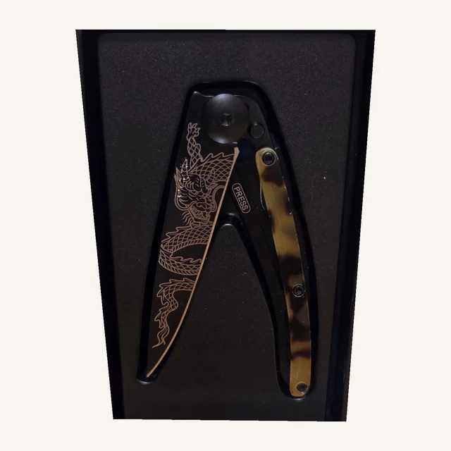 Deejo Japanese Dragon 27g knife with dragon engraving and dark-turtle handle in its black presentation box