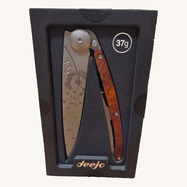 Deejo Make A Wish 37g knife with dandelion engraving and coral-wood handle in its black presentation tray