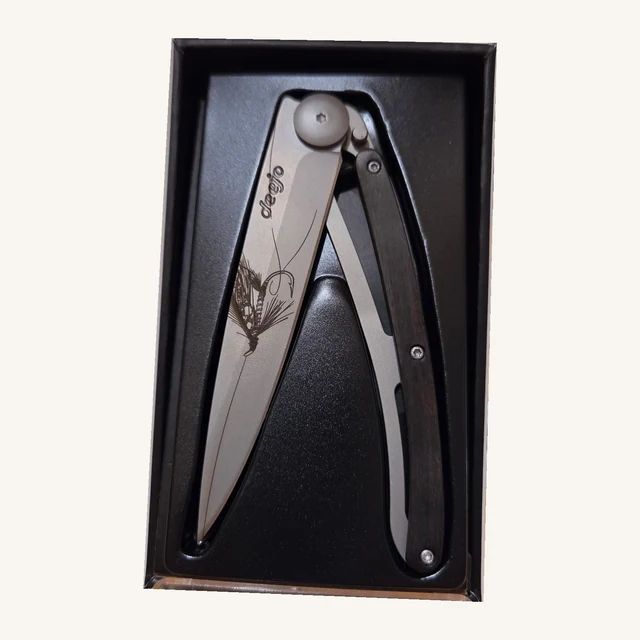Deejo Silver Wilkinson 37g folding knife with an engraved fishing-fly blade and ebony-wood handle in its black presentation tray