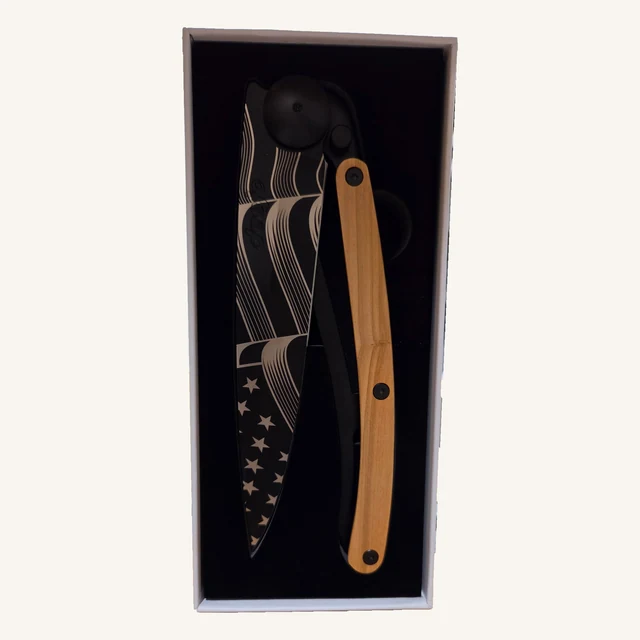 Deejo Stars & Stripes 390g knife with stars-and-stripes blade artwork and olive-wood handle in its black presentation box