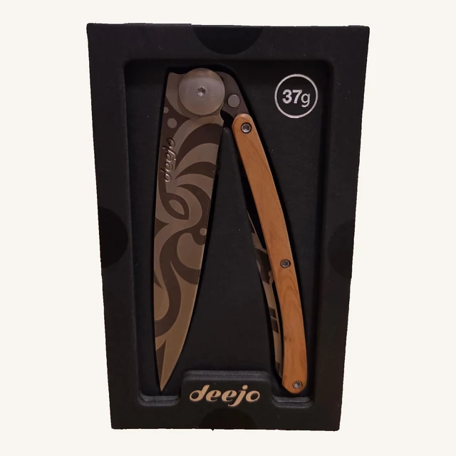 Deejo Tribal 37g folding knife with an abstract tribal-pattern blade and juniper-wood handle in its black presentation tray