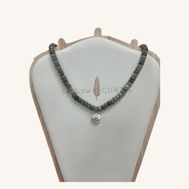Diana smoky gray faceted stone-bead necklace with a small textured silver-tone coin pendant on its original Leslie Curtis display