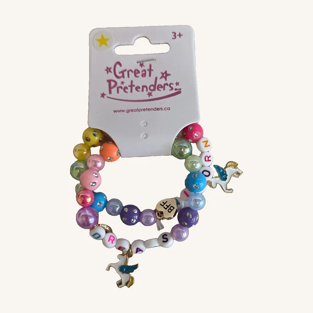 Two colorful Dreams Unicorn BFF bracelets with letter beads, winged-unicorn charms and a gold-toned BFF heart charm on the complete retail card.