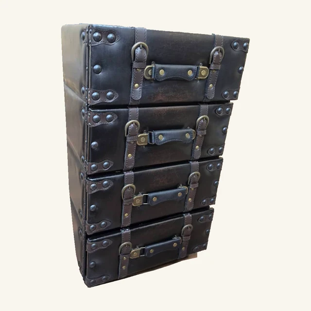 One dark four-drawer trunk-style side chest with brown buckle straps, handles and studded corners