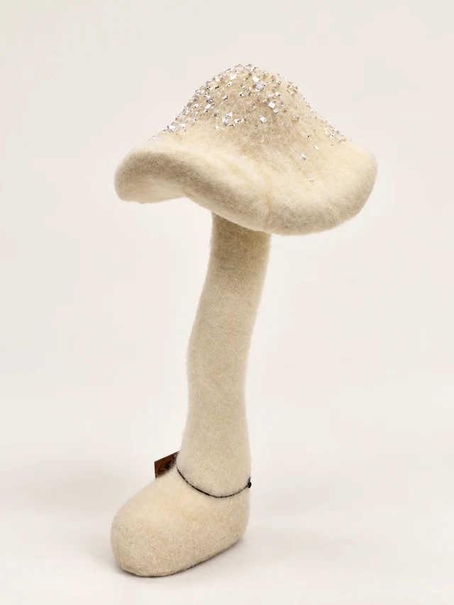 Cream fabric mushroom with an iridescent glitter cap and curved base