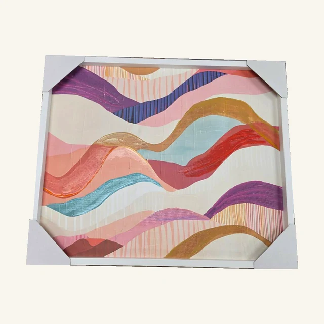 Colorful Waves Framed Canvas Wall Art. Layered waves of pink, purple, gold and blue bring a soft rhythm to this abstract composition.