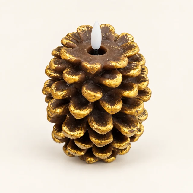 Gold-and-brown pinecone-shaped LED candle with a white flame insert on a warm off-white background