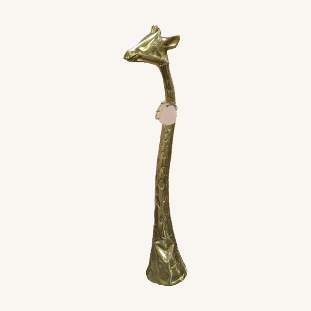 Gold-Toned Giraffe Sculpture — 28 in.. A long, slender neck and gold-toned finish give this giraffe sculpture a striking vertical presence.