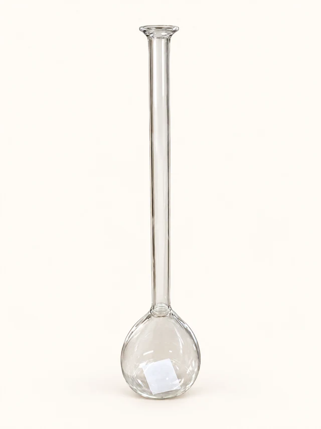 One clear Guru budvase with a rounded bulb base and very long slender neck