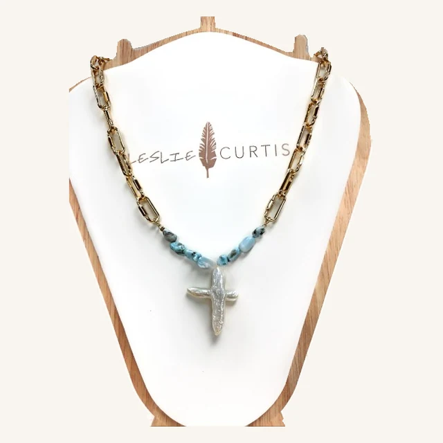 Heidi gold-tone paperclip-chain necklace with blue stone accents and a pearl cross pendant on its original Leslie Curtis display