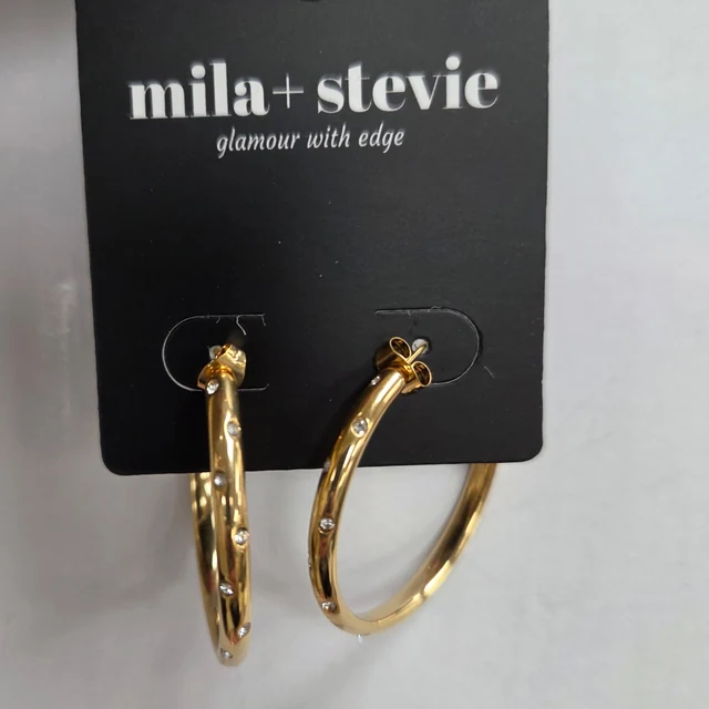 HEIDI Thin CZ Hoop Earrings. Slim gold-toned hoops and sparkling CZ accents add a little shine to an everyday look.