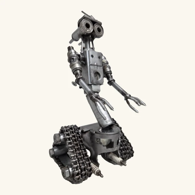Johnny Five metal robot sculpture with two round eyes, complete head and neck details, long fingered hands, chain tracks and spark-plug details at the base.