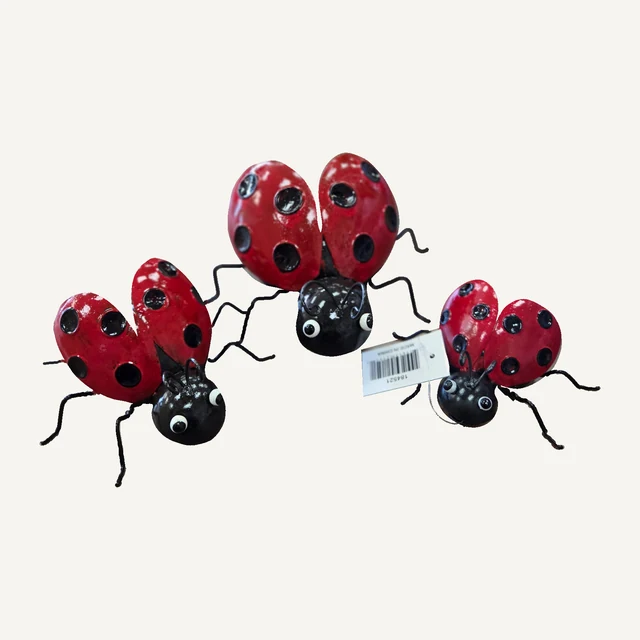 Complete set of three red-and-black decorative ladybugs with spotted wings, wire legs, curled antennae and an attached product tag