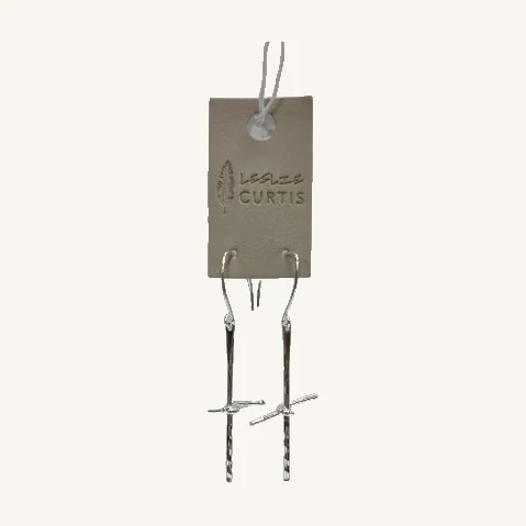 Leah Twisted Cross Earrings — Silver Tone. Slender twisted crosses and a hammered silver-toned finish create a simple, distinctive drop earring.