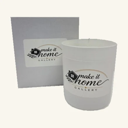Complete white Make It Home Gallery candle with its original printed gallery label, wax, wick and matching gray box