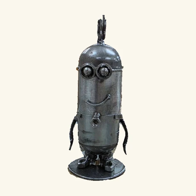 Tall silver-tone two-eyed metal Kevin sculpture with upright hair, spring-like arms and an attached round base