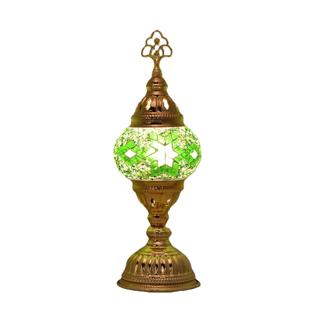 Illustrative gold-finish single-globe mosaic lamp with a green-and-white star-patterned shade on a white background. One lamp sold individually; finishes and mosaic patterns vary.