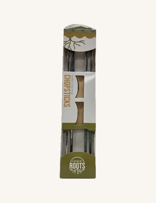 Mystic wooden chopstick set in its original sleeve, showing two pairs in purple, green and cream tones and two wooden rests