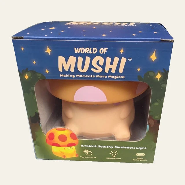 One orange World of Mushi mushroom light visible through the window of its original retail package