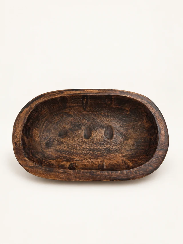 Petite dark-brown rustic oval wooden bowl viewed from above