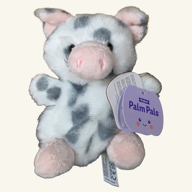 Actual gray-and-white Piggles piglet plush with pink snout and feet and its original attached tags