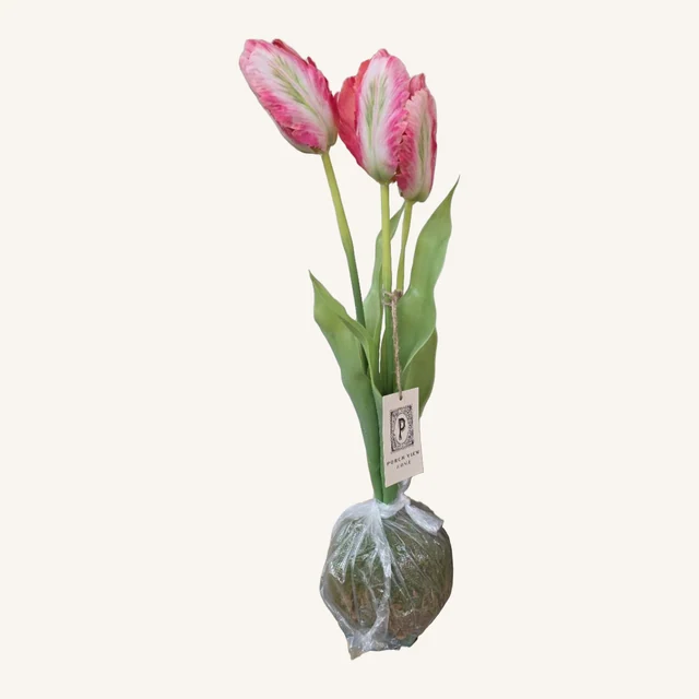 Actual artificial pink tulip arrangement with three blooms, full green stems and leaves, original tag and clear-wrapped moss-ball base