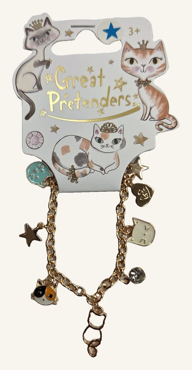 The actual gold-tone Purr-fectly Charming cat-charm bracelet, full chain and finishing links on its original printed display card.