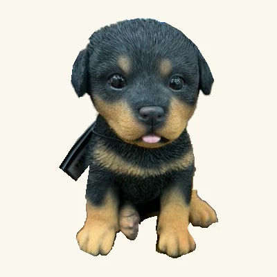 Black-and-tan Rottweiler puppy figurine with visible pink tongue, paws and its original hang tag and cord.