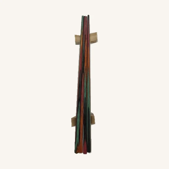 Four Shakka Guava chopsticks in red, green and dark tones with both natural-colored rests retained behind them