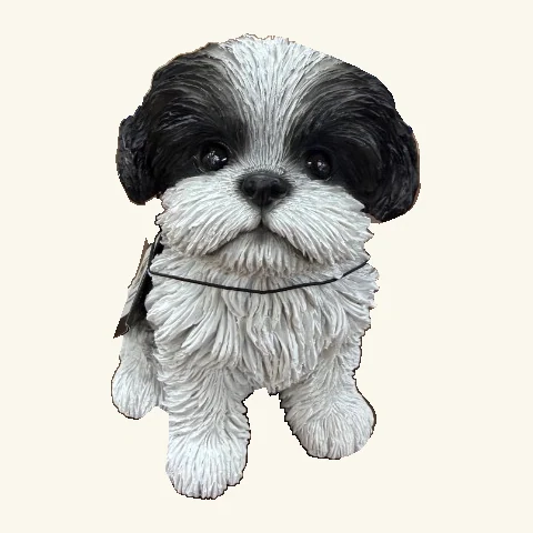 Sitting black-and-white Shih Tzu puppy figurine with long textured fur, dark ears and eyes, and its original hang tag and cord.