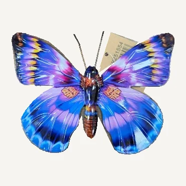 Small butterfly wall decoration with blue and purple wings, yellow accents and two antennae