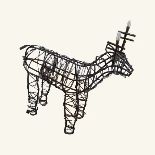 Actual small brown wire reindeer table light with its complete wire framework, four visible feet and clear light tips